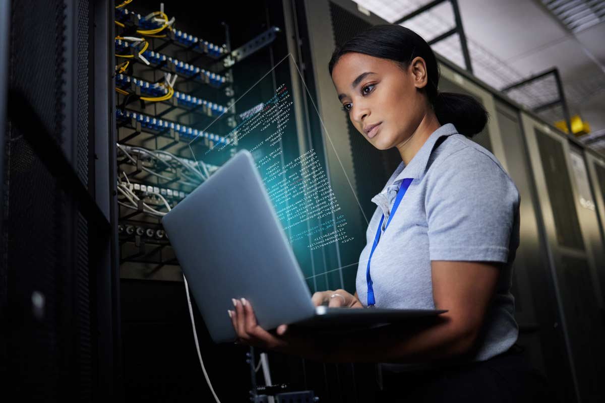 it support woman engineer working in a dark server room