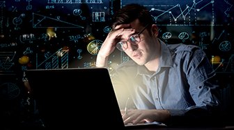 Frustrated man on laptop with graphs and charts superimposed around him
