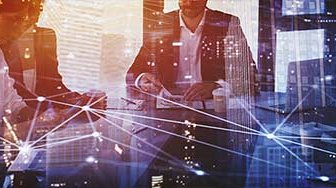 Business people sitting in desk with interconnected grid superimposed