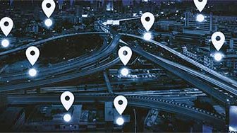 Location pin graphics superimposed on dark city highways