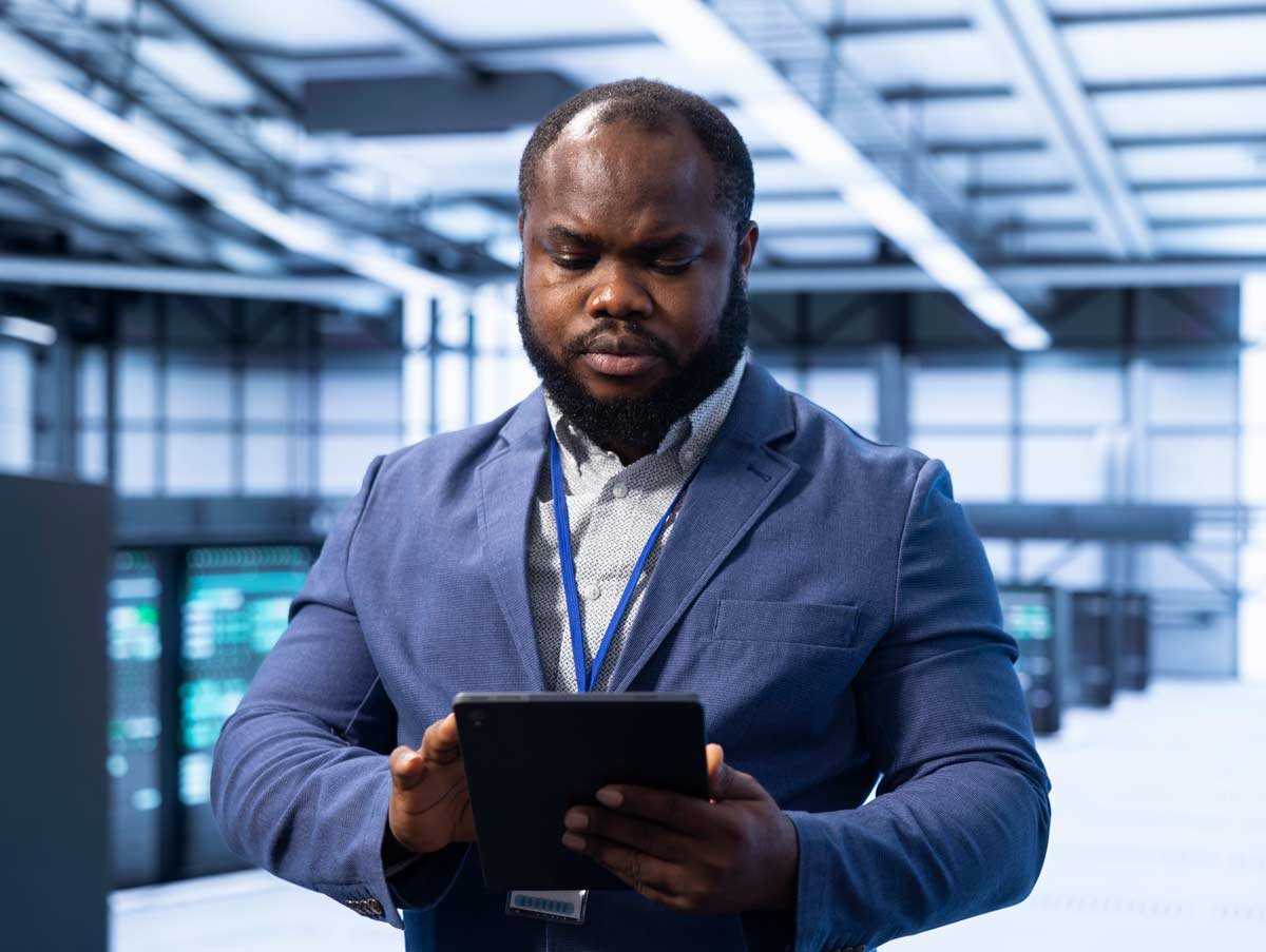 Man in suit with tablet in office