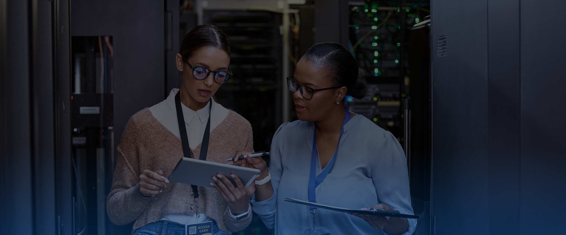 Two Female Engineers Using Tablet in server room